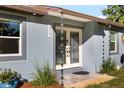 Beautiful front entrance with a custom glass double door and unique rain chains at 6907 W Creek Dr, Tampa, FL 33615