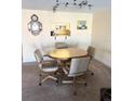 Comfortable dining area features a round wooden table and chairs, perfect for Gathering meals and gatherings at 7645 Sun Island S Dr # 306, South Pasadena, FL 33707