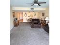 Spacious living room with neutral carpeting, comfortable seating, and ample natural light at 7645 Sun Island S Dr # 306, South Pasadena, FL 33707