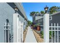 Inviting walkway featuring manicured landscaping, providing a serene path between the homes at 8116 Sanguinelli Rd, Land O Lakes, FL 34637