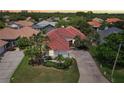 Aerial view of a beautiful home with a red tiled roof and a well-maintained lawn and garden at 915 Live Oak Ne Ter, St Petersburg, FL 33703