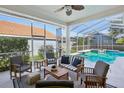 Comfortable screened in patio with cushioned seating, overlooking a private pool and backyard at 915 Live Oak Ne Ter, St Petersburg, FL 33703