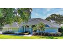 Charming single-story home featuring a beautiful tiled roof and well-manicured front yard at 9159 Highland Ridge Way, Tampa, FL 33647