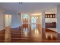 Bright, spacious living room featuring hardwood floors and arched entryways into other areas of the home at 9159 Highland Ridge Way, Tampa, FL 33647