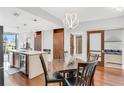 Modern dining room with a unique lighting fixture, wood floors, island with beverage cooler, and cabinets at 111 N 12Th St # 1502, Tampa, FL 33602