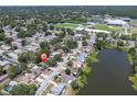 Aerial view of the property in a residential neighborhood with a nearby lake at 1428 Chesterfield Dr, Dunedin, FL 34698