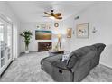 Relaxing living room featuring a gray couch and decorated with art at 1428 Chesterfield Dr, Dunedin, FL 34698