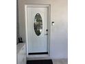 Elegant white front door with an oval glass insert and modern security features at 1748 Ragland Ave, Clearwater, FL 33765