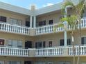 Multi-level condo building with outdoor balconies and tropical landscaping, offering a relaxed living environment at 2331 Finlandia Ln # 73, Clearwater, FL 33763