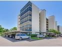 Low angle shot of the building's facade and attached parking, showing the balconies and large windows at 2700 Cove Cay Dr # 1-2D, Clearwater, FL 33760