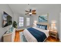 Cozy bedroom with a decorative ceiling fan, hardwood floors, and an inviting queen-sized bed at 2739 Via Capri # 1024, Clearwater, FL 33764