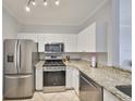 Bright kitchen features stainless steel appliances and granite countertops at 2739 Via Capri # 1024, Clearwater, FL 33764