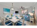 Bright living room features coastal decor, tile floors and a sliding door leading to an outdoor patio at 2739 Via Capri # 1024, Clearwater, FL 33764