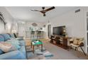 Cozy living room with modern ceiling fan, bar seating and view to kitchen and front door at 3001 58Th S Ave # 509, St Petersburg, FL 33712
