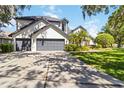 White stucco home with a spacious three car garage and concrete driveway at 3329 Cypress Landing Dr, Valrico, FL 33596