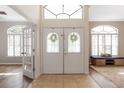 Bright foyer showcasing tiled floors, high ceilings, and a large arched window at 3329 Cypress Landing Dr, Valrico, FL 33596