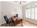 Office featuring wood floors, a large arched window, and a comfortable desk at 3329 Cypress Landing Dr, Valrico, FL 33596