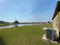 Expansive backyard featuring green grass and a beautiful water view at 35003 Daisy Meadow Loop, Zephyrhills, FL 33541