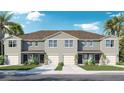 Charming two-story townhome features a well-manicured lawn, driveway, garage, neutral paint and a well-kept roof at 431 Warm Heron Pl, Ruskin, FL 33570