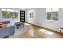Sunlit living room with wood floors, light gray walls, modern windows and stylish front door at 4730 15Th N Ave, St Petersburg, FL 33713
