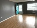 Bright living room boasting stylish flooring, neutral walls, bright natural light, and a charming blue door at 5940 30Th S Ave # 206, Gulfport, FL 33707