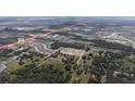 Aerial view displays surrounding community, neighborhood streets and highways at 6652 Simmons Loop, Riverview, FL 33578