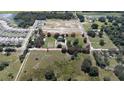 Aerial view showing the spacious lot with mature trees and surrounding residential area at 6652 Simmons Loop, Riverview, FL 33578