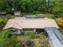 An aerial view of the home showcasing a metal roof and the well-maintained backyard at 117 Myrtle Ln, Plant City, FL 33565