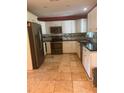 Well-lit kitchen with stainless steel appliances, granite countertops, and white cabinets at 1203 Durant Rd, Brandon, FL 33511