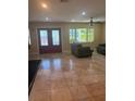 Spacious living room featuring tile floors, neutral paint, and a bright window at 1203 Durant Rd, Brandon, FL 33511