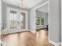 Elegant foyer features wood flooring and a decorative glass double door at 12795 Fisherville Way, Riverview, FL 33579