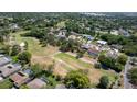 Aerial view of a neighborhood backing onto a golf course with mature trees and well-maintained landscaping at 12904 Teakwood Ln, Hudson, FL 34667