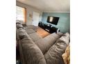 Comfortable living room with a large sectional couch, TV, and bright natural light at 1407 College Park Ln, Tampa, FL 33612