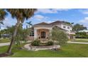 Charming home with lush landscaping and a welcoming entryway with a curved brick walkway at 1915 Belleair Rd, Clearwater, FL 33764
