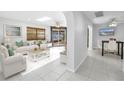 Light and airy living room with a sky light and seamless access to the outdoors at 2800 Gulf Blvd Unit # 1A, Belleair Beach, FL 33786