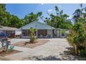 Charming single story home featuring a screened porch, landscaped front yard and spacious driveway at 3105 Gordon Ct, Tampa, FL 33619