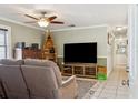 Comfortable living room featuring neutral paint, a ceiling fan, tile floors and a view into the hall at 3105 Gordon Ct, Tampa, FL 33619