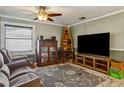 Comfortable living room featuring neutral paint, a ceiling fan, tile floors and a view into the hall at 3105 Gordon Ct, Tampa, FL 33619