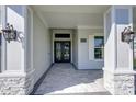Welcoming entryway with stone pillars, stylish lanterns, and a view through double doors at 324 3Rd N Ave, Safety Harbor, FL 34695