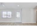 Bright entryway featuring laminate flooring, a new front door, and a large window for natural light at 3404 33Rd Street W Ct, Bradenton, FL 34205