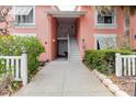 Condo entrance with white stairs, walkway, well-maintained plants, and white fence at 3675 41St S Way # K, St Petersburg, FL 33711