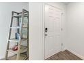 Clean and modern entryway with wood-look tile and a stylish shelving unit at 3879 E Price Blvd, North Port, FL 34288