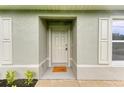 Inviting front entrance with a welcoming doormat and stylish shutters at 3879 E Price Blvd, North Port, FL 34288