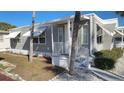 Inviting front porch with white railings offers a charming entrance to this lovely home with mature trees at 4851 W Gandy Blvd # B12L28, Tampa, FL 33611
