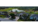 A charming home nestled in a picturesque neighborhood with lush greenery, a tranquil pond, and a nearby golf course at 522 Planters Manor Way, Bradenton, FL 34212