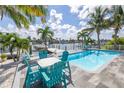 Relaxing pool area with comfortable seating, tropical landscaping, and water access at 533 Lillian Dr, Madeira Beach, FL 33708