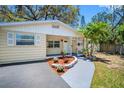 Charming single-story home with a well-maintained front yard, vibrant flowers and a cozy, covered entryway at 568 La Plaza S Ave, St Petersburg, FL 33707