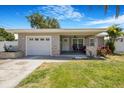 Welcoming front porch with neutral siding, stone accents, and cozy seating area at 5800 Dartmouth N Ave, St Petersburg, FL 33710