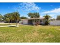 Well-maintained single-story home with a lush green lawn, driveway, and neat landscaping at 5800 Dartmouth N Ave, St Petersburg, FL 33710