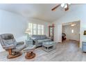 Comfortable living room with gray furniture, plantation shutters, and laminate flooring at 5906 Greenbriar Ct, Zephyrhills, FL 33542